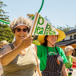 Suzanne Olson waves Pea Patch flag in 4th of July parade